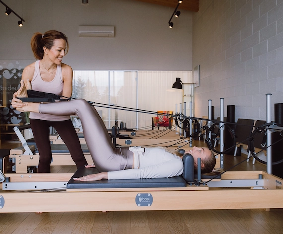 Personaaltreening Bluebird stuudios Laagris – treener juhendab klienti Pilates Reformer harjutuses, keskendudes tehnikale ja lihaste aktiveerimisele.
